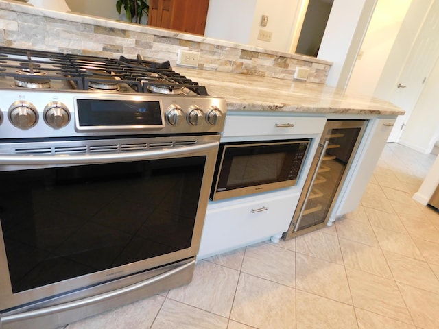 120 Bellevue St Unit 4, Owls Head, ME 04854 - kitchen featuring gas range, built in microwave, decorative backsplash, and light stone countertops