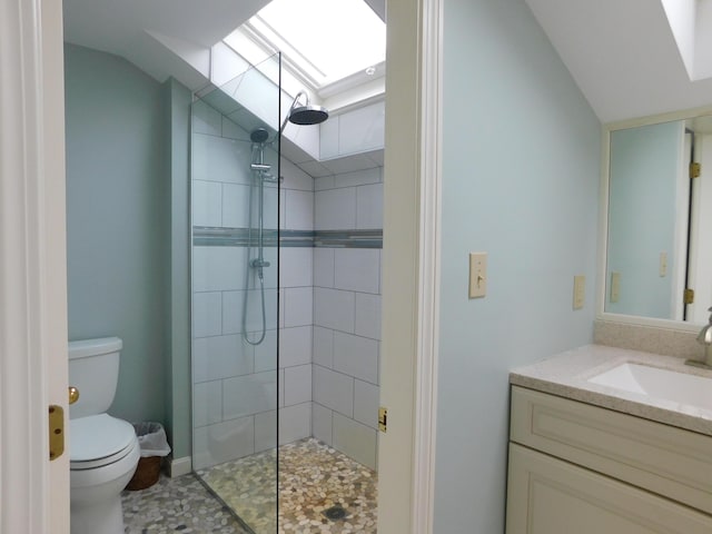 120 Bellevue St Unit 4, Owls Head, ME 04854 - full bathroom with a skylight, toilet, vaulted ceiling, tiled shower, and vanity