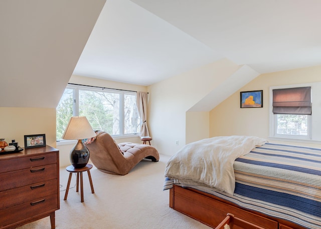 bedroom with light colored carpet and vaulted ceiling