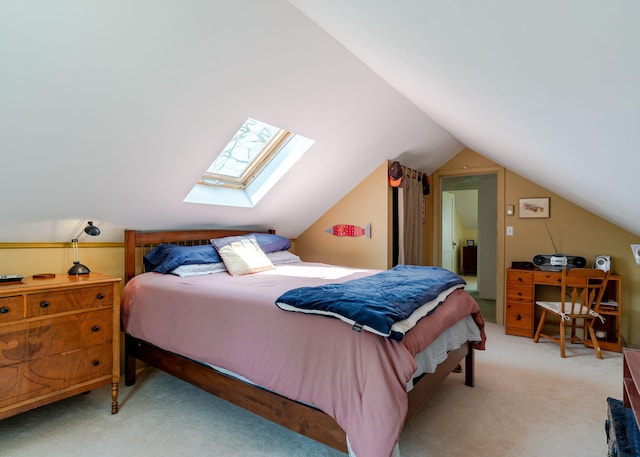 bedroom featuring lofted ceiling with skylight and light carpet