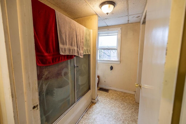 full bathroom featuring toilet, tile patterned floors, a paneled ceiling, an enclosed shower, and visible vents