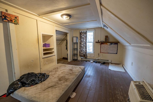 bedroom with heating unit, lofted ceiling, a baseboard heating unit, hardwood / wood-style flooring, and a closet