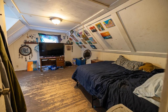 bedroom featuring wood finished floors and lofted ceiling