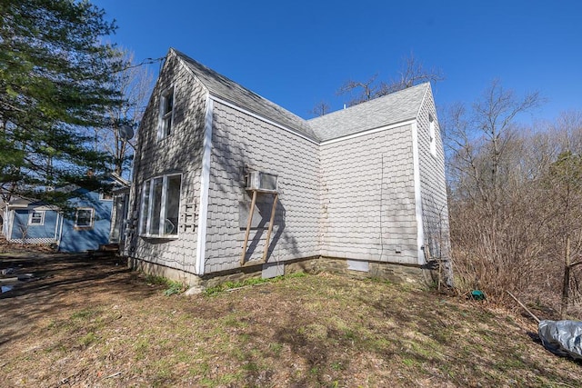 view of side of property featuring a gambrel roof
