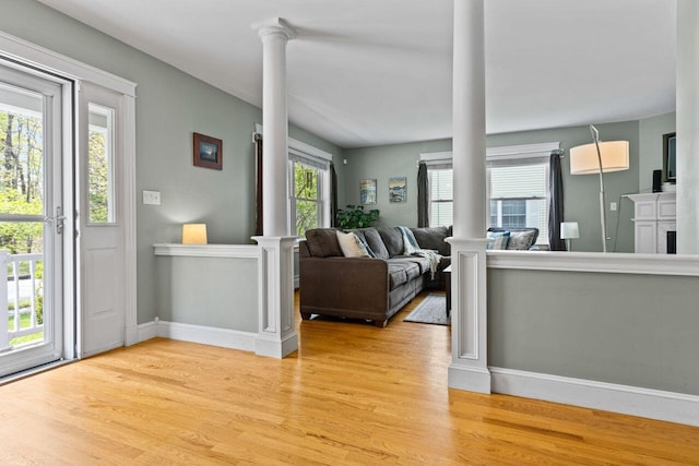 134 Yale St, Portland, ME 04103 - living area with decorative columns, light wood-style flooring, and baseboards