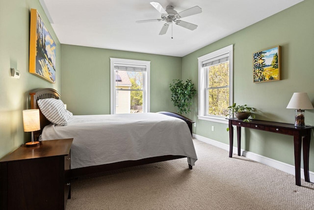 134 Yale St, Portland, ME 04103 - bedroom featuring multiple windows, baseboards, carpet floors, and ceiling fan