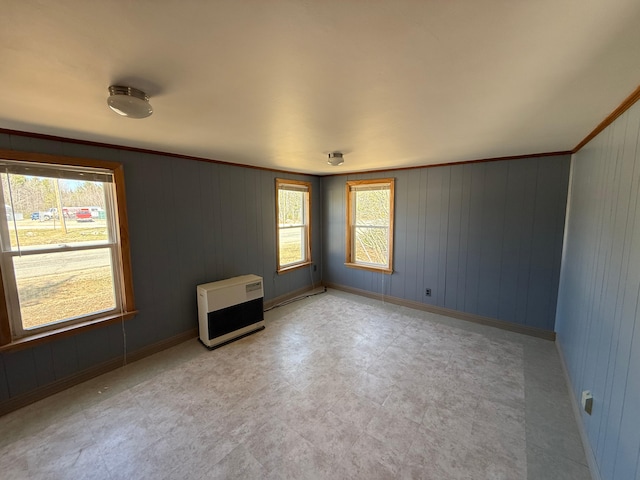 633 Norway Rd, Harrison, ME 04040 - empty room with heating unit, light floors, and wooden walls