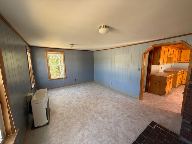 633 Norway Rd, Harrison, ME 04040 - interior space featuring arched walkways, baseboards, wood walls, and crown molding