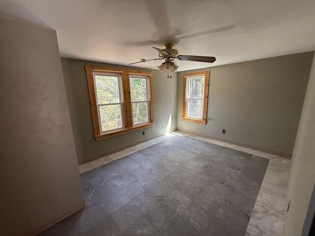 633 Norway Rd, Harrison, ME 04040 - empty room featuring baseboards, stone finish flooring, and ceiling fan