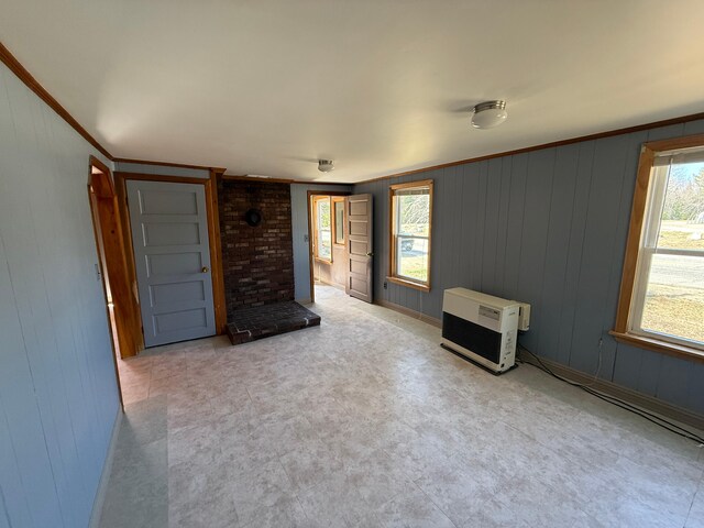 633 Norway Rd, Harrison, ME 04040 - unfurnished living room with heating unit, tile patterned floors, wooden walls, and ornamental molding