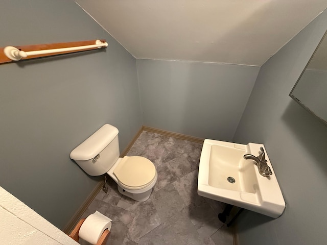 633 Norway Rd, Harrison, ME 04040 - half bath with lofted ceiling, baseboards, toilet, and a sink