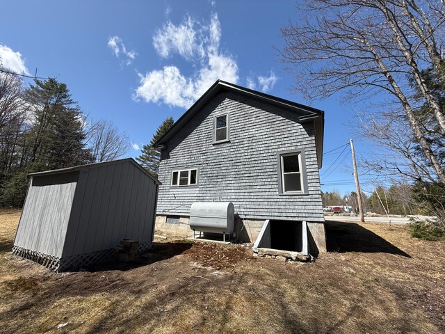 633 Norway Rd, Harrison, ME 04040 - rear view of property with heating fuel, an outdoor structure, and a storage unit