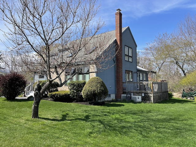 16 Howard Ave Unit 16, Wells, ME 04090 - view of side of property featuring a lawn, a wooden deck, and a chimney