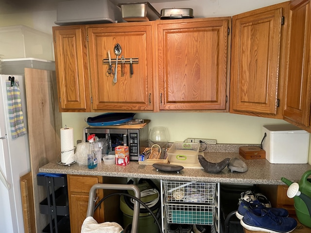 16 Howard Ave Unit 16, Wells, ME 04090 - kitchen with light countertops, stainless steel microwave, and brown cabinets