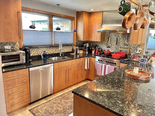 16 Howard Ave Unit 16, Wells, ME 04090 - kitchen with wall chimney range hood, a sink, a toaster, dark stone counters, and stainless steel appliances