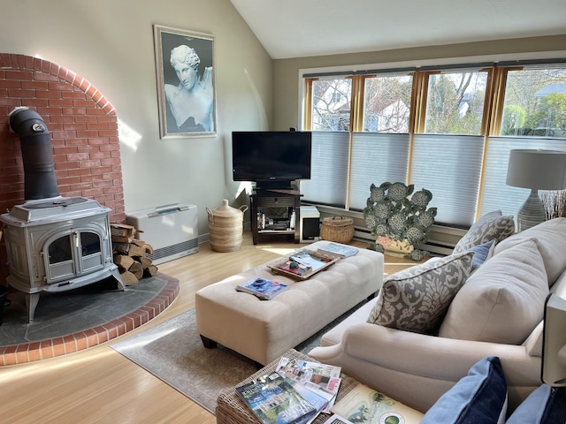 16 Howard Ave Unit 16, Wells, ME 04090 - living area featuring a wood stove, baseboards, wood finished floors, and lofted ceiling