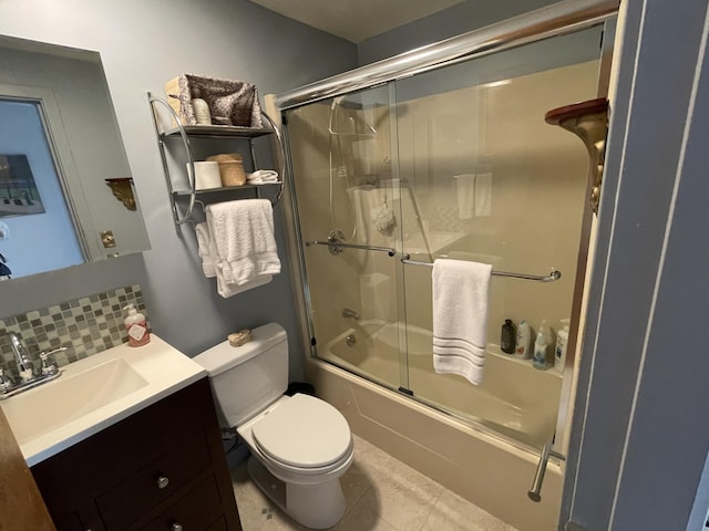 16 Howard Ave Unit 16, Wells, ME 04090 - full bath featuring shower / bath combination with glass door, tile patterned flooring, vanity, toilet, and tasteful backsplash
