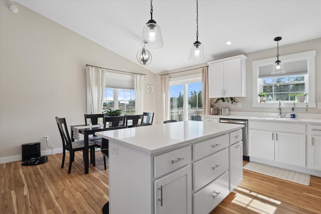 kitchen featuring a sink, pendant lighting, a wealth of natural light, and light countertops
