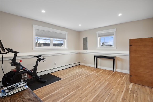 workout room featuring baseboards, plenty of natural light, recessed lighting, and wood finished floors