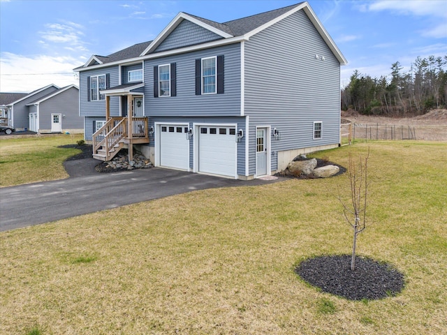 view of front facade featuring a garage, fence, driveway, and a front yard