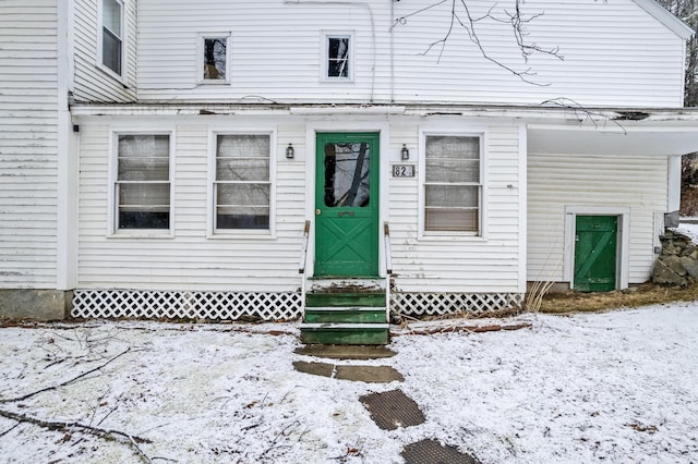 view of snow covered property entrance