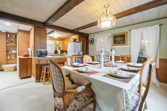 dining space with beamed ceiling and wooden ceiling