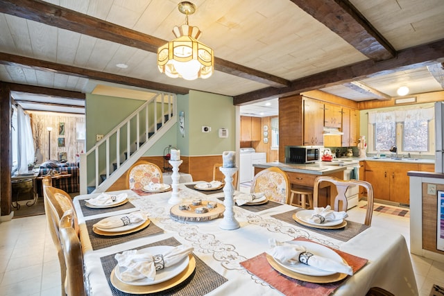 dining space with beam ceiling, stairway, a healthy amount of sunlight, and wood ceiling