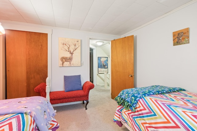 carpeted bedroom with ornamental molding
