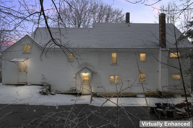 view of home's exterior featuring a chimney and a shingled roof