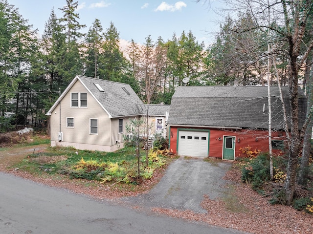 86 Webb Cove Dr, Lowell, ME 04493 - view of side of home featuring driveway, roof with shingles, and an attached garage