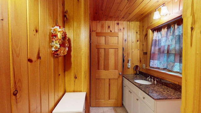 86 Webb Cove Dr, Lowell, ME 04493 - bathroom with wood walls, tile patterned flooring, vanity, and wooden ceiling