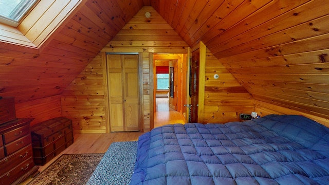 86 Webb Cove Dr, Lowell, ME 04493 - bedroom with wooden ceiling, wooden walls, light wood-style flooring, and vaulted ceiling with skylight