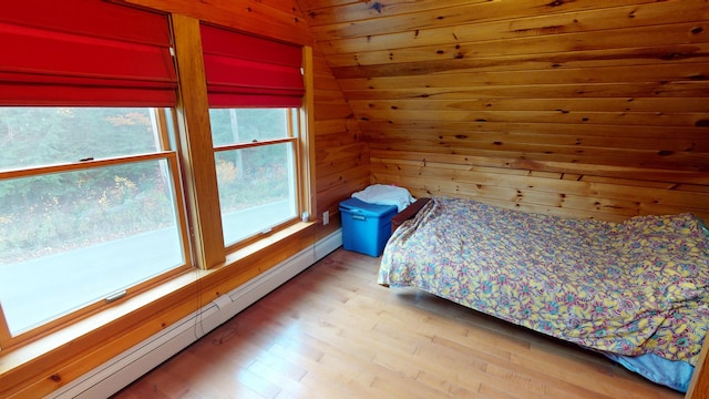 86 Webb Cove Dr, Lowell, ME 04493 - bedroom with wooden walls, light wood-style flooring, lofted ceiling, and a baseboard radiator