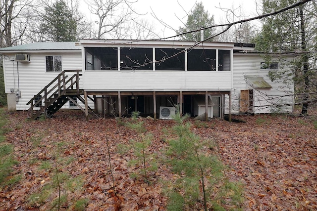 back of property featuring a wall unit AC, stairs, a sunroom, and ac unit