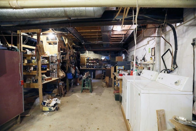 unfinished basement featuring a workshop area and washer and clothes dryer