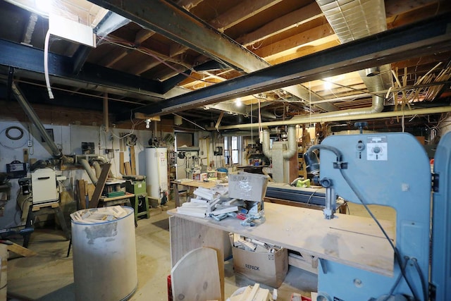 below grade area with a workshop area and water heater