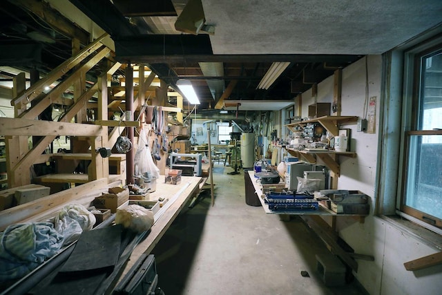 misc room with a workshop area, plenty of natural light, and unfinished concrete floors