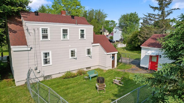 74 Silk St, Brewer, ME 04412 - rear view of property with a fenced backyard, a chimney, and a shingled roof