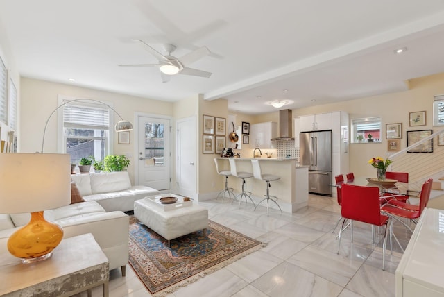 living room with ceiling fan and washer / clothes dryer