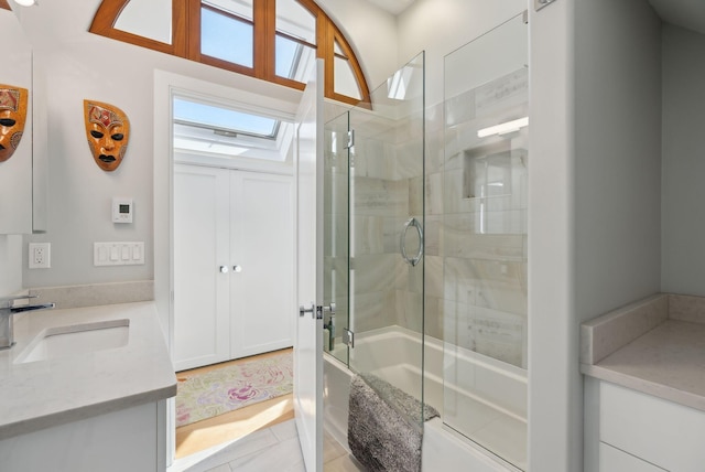 bathroom with vanity and combined bath / shower with glass door
