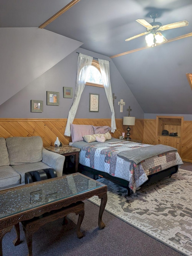 704 Kennebec River Rd, Embden, ME 04958 - bedroom with wood walls, wainscoting, lofted ceiling, ceiling fan, and carpet