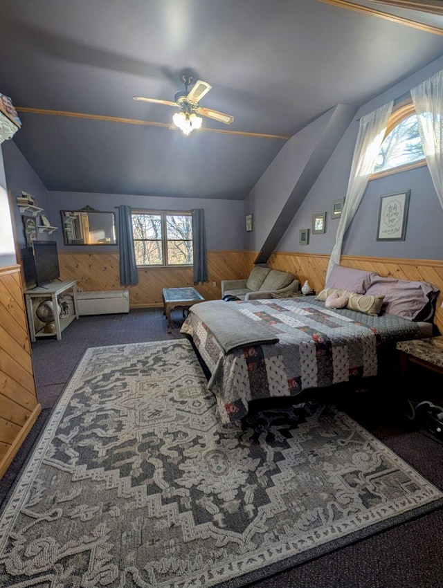 704 Kennebec River Rd, Embden, ME 04958 - carpeted bedroom featuring wood walls, multiple windows, and lofted ceiling
