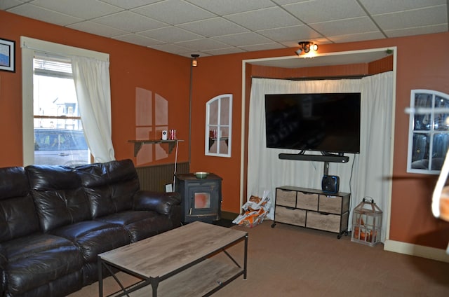 13 Hazen St, Norway, ME 04268 - living area with baseboards, a wood stove, carpet, and a drop ceiling