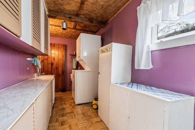 laundry room featuring laundry area and stacked washer and clothes dryer