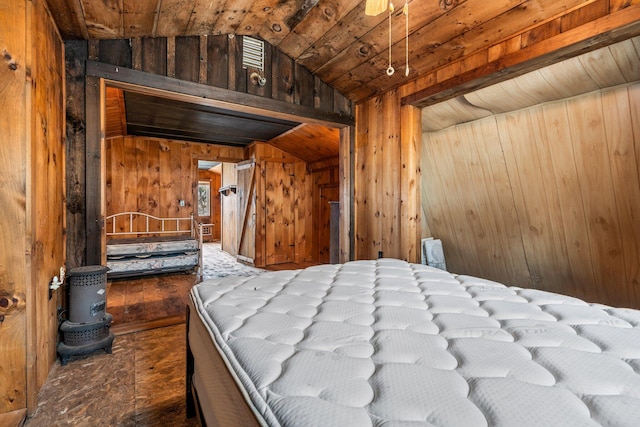 bedroom with wooden walls and lofted ceiling