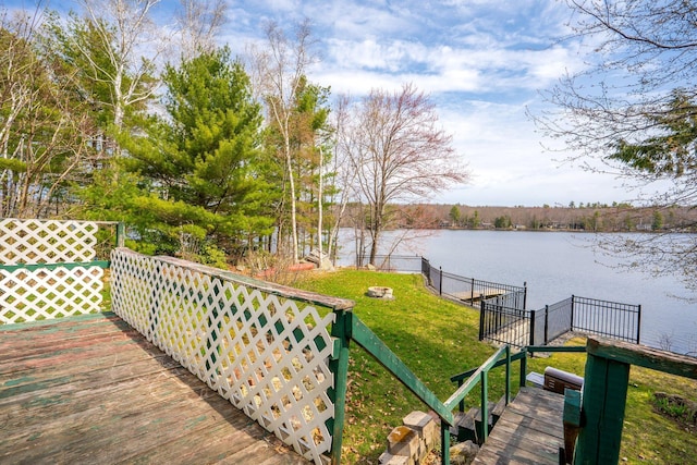 wooden terrace with a lawn and a water view