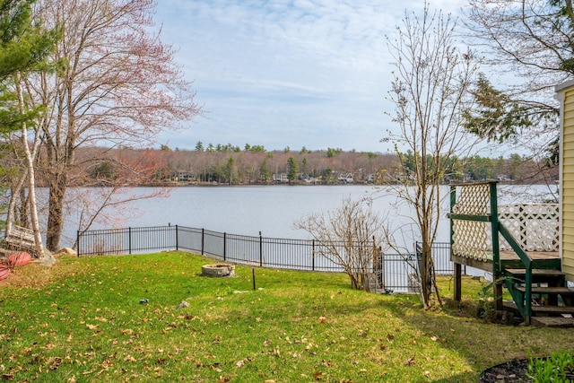view of yard featuring fence and a water view