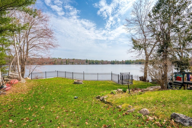 view of yard featuring a water view and fence