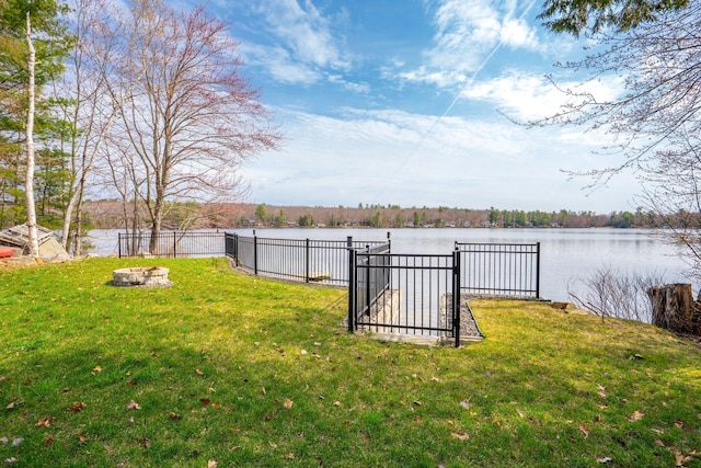 view of yard with a water view and fence