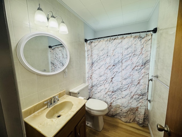 10 Laurette Cir, Caribou, ME 04736 - bathroom with tile walls, wood finished floors, vanity, crown molding, and toilet